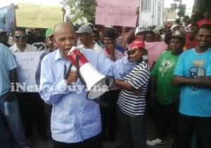 General Secretary of the PPP, Clement Rohee leads the protest in front of Parliament. 