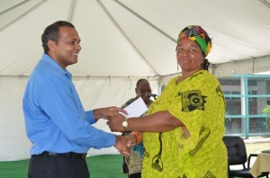 A member from one of the African Cultural groups receiving a cheque from Minister of Culture, Youth and Sport Dr. Frank Anthony.