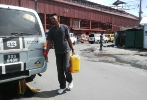 Fisherman Mohan Sukhan travelled from Canal Number One, West Bank Demerara to purchase fuel in Georgetown so that he can operate his boat. [iNews' Photo]