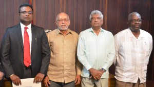 GECOM Commissioner Sase Gunraj standing besides former President Donald Ramotar; GECOM's Chairman, Dr Steve Surujbally and CEO of GECOM, Keith Lowenfield