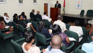 Minister of State, Joseph Harmon addressing reporters at the press conference.