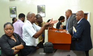 Minister of Governance, Raphael Trotman interacts with members of the media shortly after the press conference. [Jules Gibson Photo]