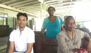 Mr. Ramdehall and Ms. Benjamin awaiting the water taxi at New Amsterdam stelling. In the middle is Ms. Taylor from Ithaca. 