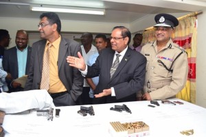 Prime Minister, Moses Nagamootoo, Public Security Minister Khemraj Ramjattan and Police Commissioner Seelall Persaud during the inspection of the arms and ammunitions that were handed over.