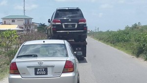 SEIZED: One of BaiShanLin's luxury vehicle [a black Lexus) being towed away