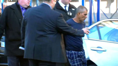 Prem Rampersaud as he was being placed in a police car. [ABC7 Eyewitness News photo)